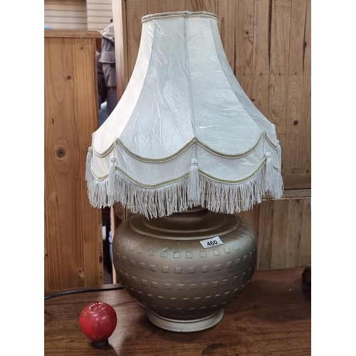 460 - A very elegant table lamp with a dark gold metal base and relief geometric patterning. Topped with a... 