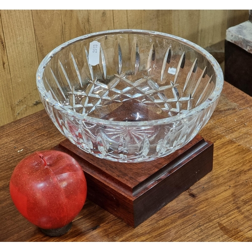 463 - A very elegant Waterford Crystal bowl in the Lismore pattern. Supported by a turned wooden podium ba... 