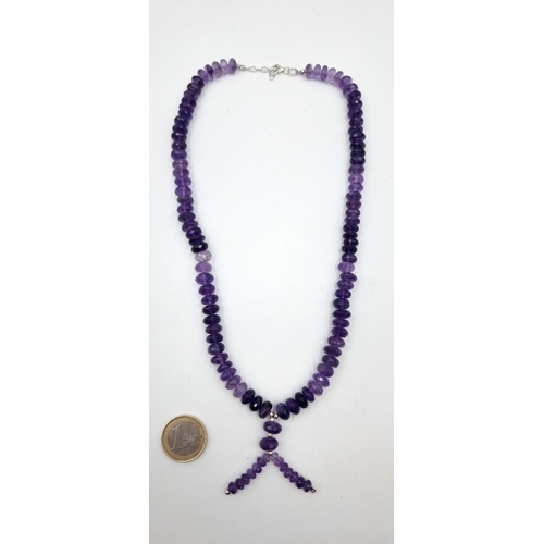 7 - A stunning Amythyst stone single strand graduated necklace, with a pretty tassel accent. This exampl... 