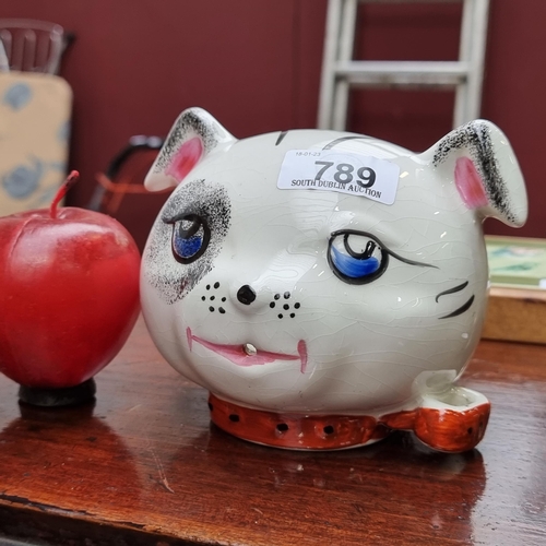 A vintage porcelain Arthur Wood wall hanging string dispenser in