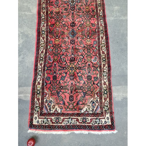 448 - Star Lot : A handwoven Hamadan runner rug in shades of red with multicoloured detailed pattern and c... 