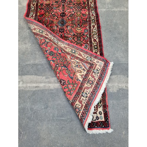 448 - Star Lot : A handwoven Hamadan runner rug in shades of red with multicoloured detailed pattern and c... 