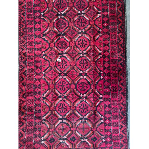 449 - A handwoven Iranian rug with an elaborate design in fabulous vivid red and black. Very short fringe.... 