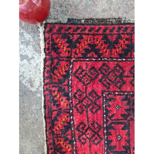 449 - A handwoven Iranian rug with an elaborate design in fabulous vivid red and black. Very short fringe.... 