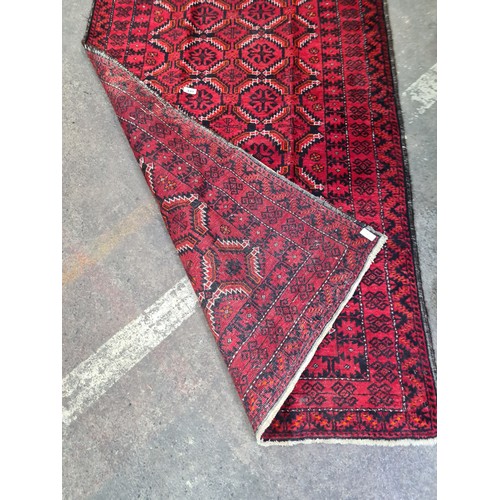 449 - A handwoven Iranian rug with an elaborate design in fabulous vivid red and black. Very short fringe.... 