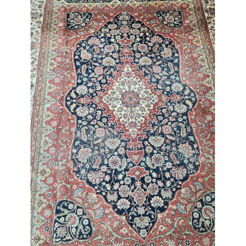 450 - A fantastic wool rug in shades of terracotta with navy, pink and cream detail. With long cream fring... 