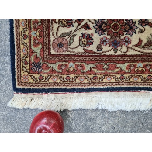 450 - A fantastic wool rug in shades of terracotta with navy, pink and cream detail. With long cream fring... 