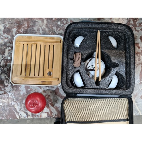 464 - An as new, vintage style Japanese travel tea-set. Containing trivet, teapot, tongs, four cups and a ... 