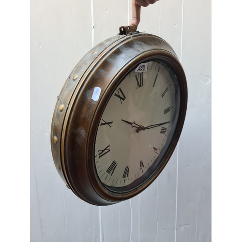 288 - A double sided wall clock in the form of a vintage railway station clock. Featuring brass toned beze... 