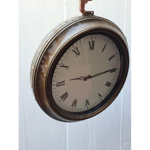 288 - A double sided wall clock in the form of a vintage railway station clock. Featuring brass toned beze... 