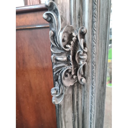 495 - A stylish large heavy wall overmantel  beveled mirror with ornate frame in a brushed silver finish. ... 