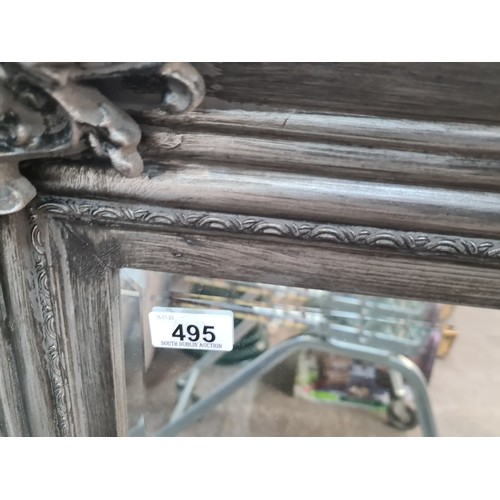 495 - A stylish large heavy wall overmantel  beveled mirror with ornate frame in a brushed silver finish. ... 