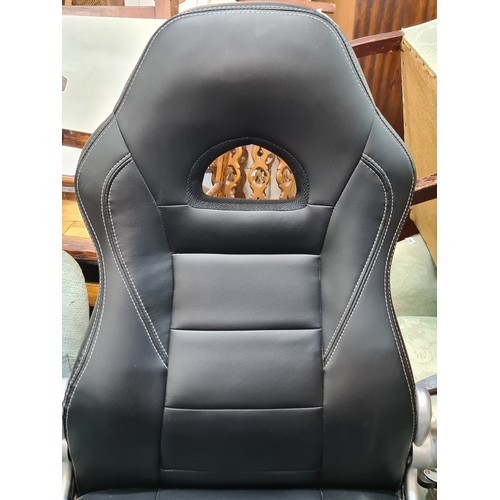 429 - A Songmics office black leather  gaming chair on a swivel base set on castors. With comfortable arm ... 