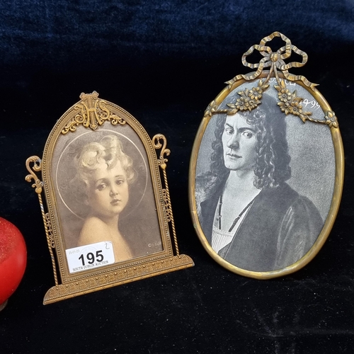 195 - A pair of antique  brass picture frames including a Roman Catholic example with an IHS crested detai... 