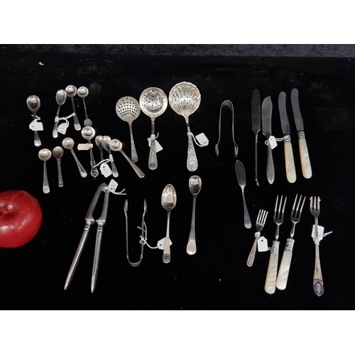 275 - Twenty-eight pieces of silver plated cutlery including various sugar spoons, sugar cube tongs, tea b... 