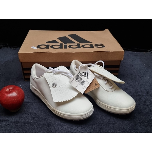 A pair of brand new Adidas Cruiser white leather spiked golf shoes. Size UK 4. Similar RRP for 1