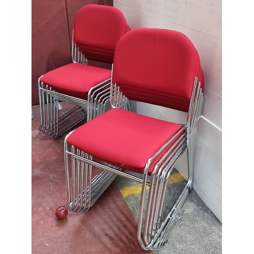 364 - A set of twelve office stacking chairs.  Designed with a polished chrome frame and striking red upho... 