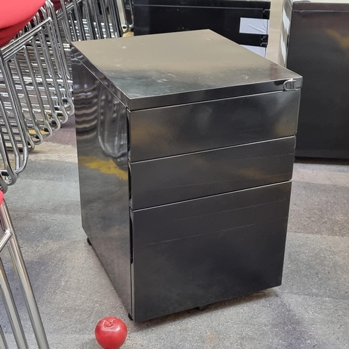 380 - A filing cabinet with lock to front, three drawers, one large and two smaller to top. In a black chr... 