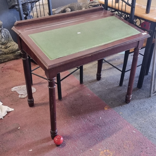 639 - A handsome sloped writing desk with green leather slope, pen rest and two good sized compartments in... 