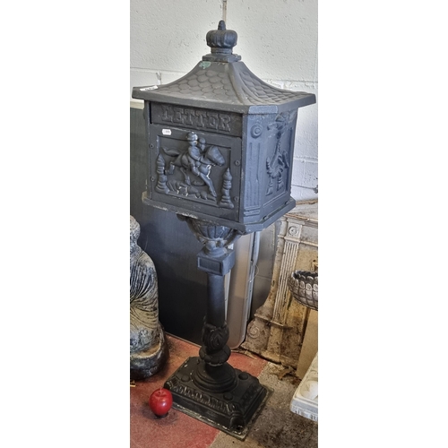 645 - A very nice cast metal, free standing letter box. With classical elements throughout, a central cava... 