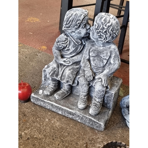 650 - A very heavy, high quality garden ornament of two adorable children perched on a bench.