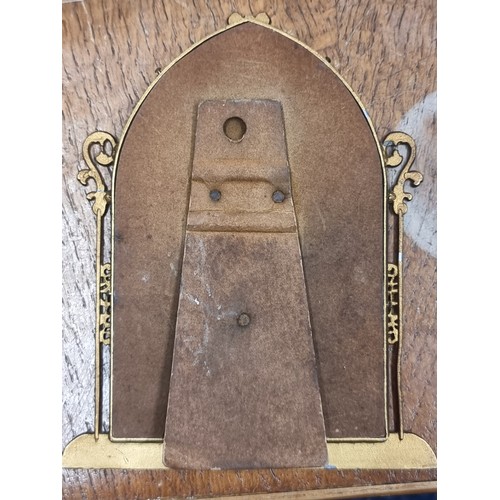 195 - A pair of antique  brass picture frames including a Roman Catholic example with an IHS crested detai... 