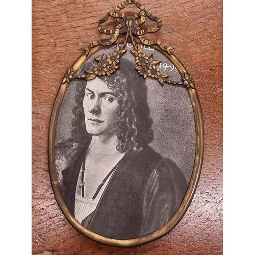 195 - A pair of antique  brass picture frames including a Roman Catholic example with an IHS crested detai... 