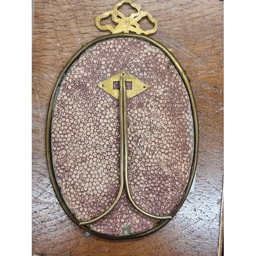 195 - A pair of antique  brass picture frames including a Roman Catholic example with an IHS crested detai... 