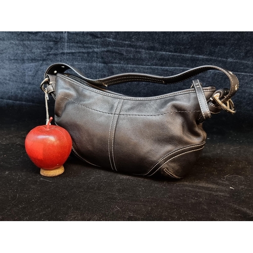 100 - A striking genuine cowhide leather ladies handbag by designer brand Coach. Designed in the Soho Hobo... 