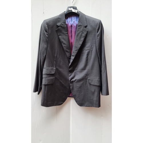 130 - A well tailored suit jacket by Nicky Wallace in a stylish grey. Interior lined with an opalescent bl... 