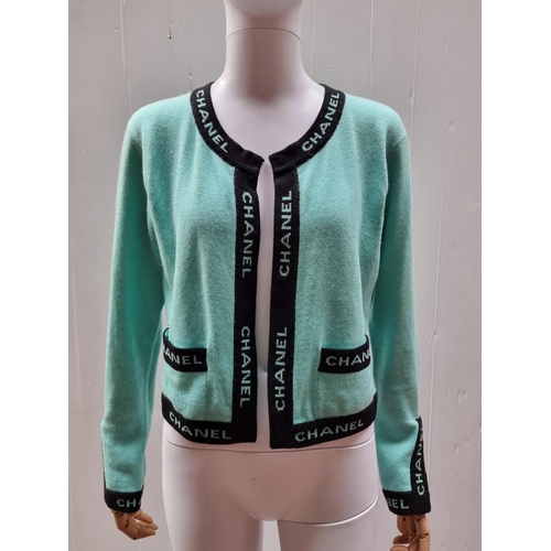 153 - Star Lot : A beautiful vintage cashmere cardigan by Chanel. A striking 100% cashmere example in a tu... 