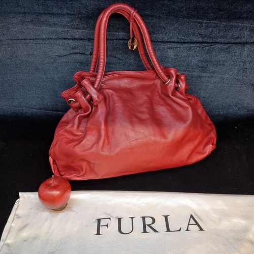 78 - A striking genuine leather ladies handbag by designer brand Furla. An elegant example in a ruby red ... 