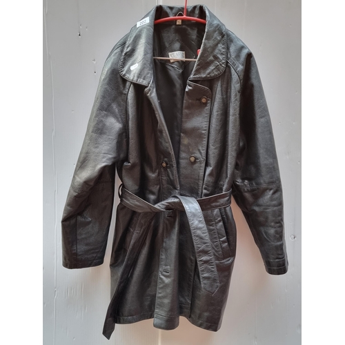 202 - A fantastic vintage double breasted genuine leather coat with matching belt. Features a padded lined... 