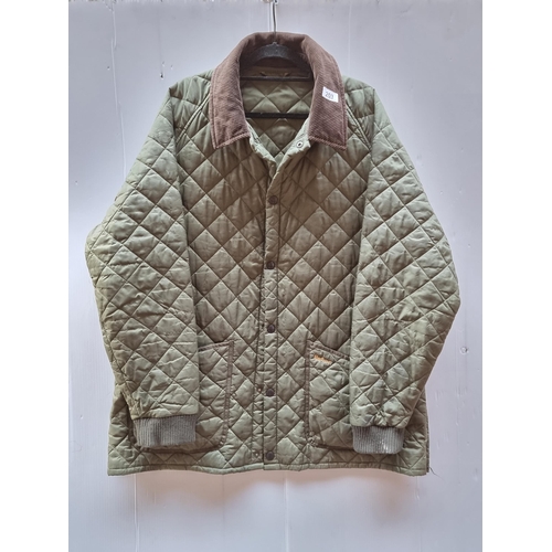 203 - A brilliant quilted Barbour jacket in a forest green. Features brown corduroy collar and two large p... 