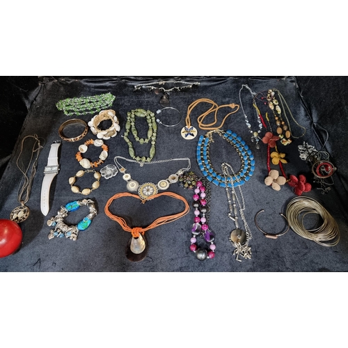 221 - A large bag of mixed costume jewellery. Dozens of pieces included ranging from large beaded necklace... 