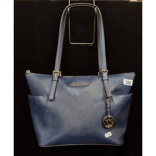 225 - A stylish ladies handbag by designer brand Michael Kors. Designed in a rich navy blue with branded h... 