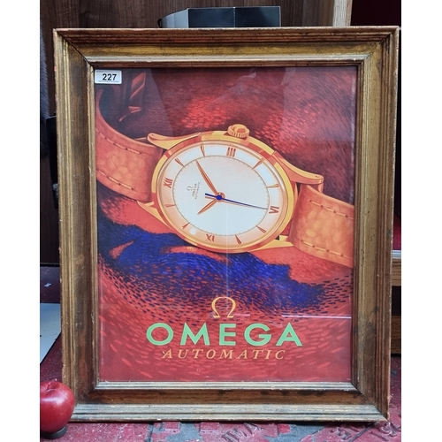 227 - A large print of an advertisement for Omega  Automatic Watches in a gilt frame.