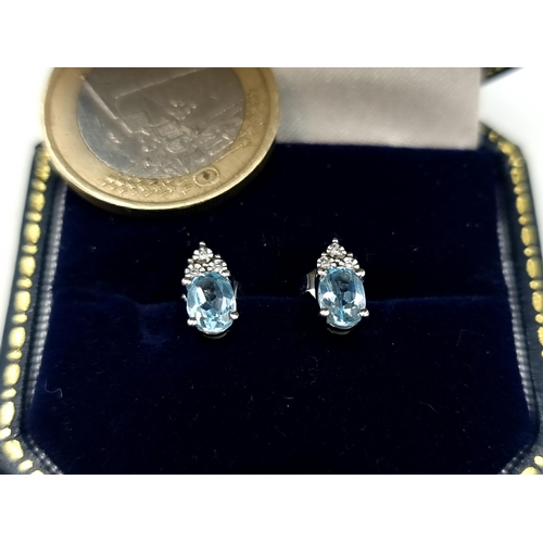 238 - Star Lot: A beautiful pair of 9 carat White Gold Diamond and Aquamarine stud earrings. These example... 