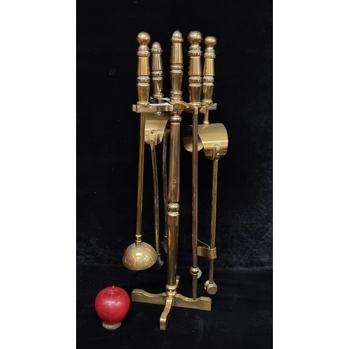 312 - A very heavy  solid brass companion stand including two tongs, a poker and brush. losses to the brus... 