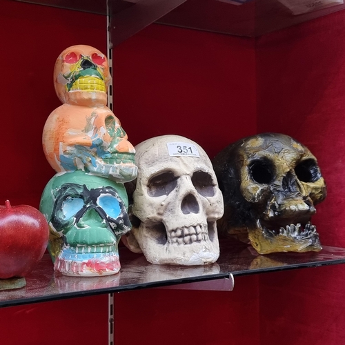 351 - A selection of three ornamental skulls including a stacked trio ceramic example in bright shades. Al... 