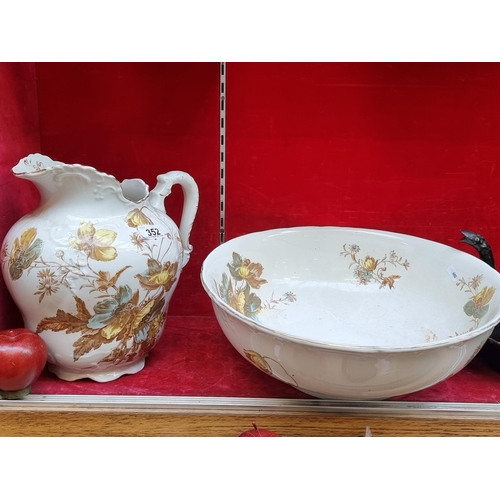 352 - A very large antique pitcher and wash basin porcelain set by Bishop & Stonier. Featuring floral desi... 