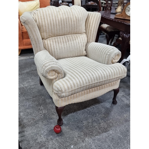 678 - A wonderful oversized wingback armchair with removable cushions and upholstered in an elegant cream ... 