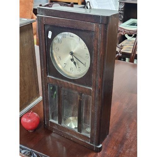 683 - A charming early 20th century wall clock. Featuring bevelled glass panes and a convex glass dial win... 