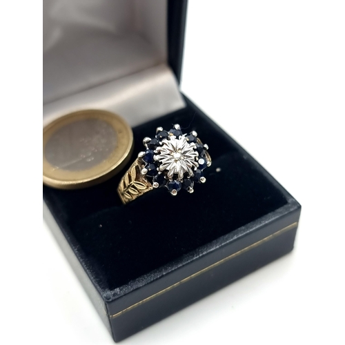 700 - A fine example of a 9 carat Gold Diamond and Sapphire cluster ring, set beautifully with wide leaf s... 