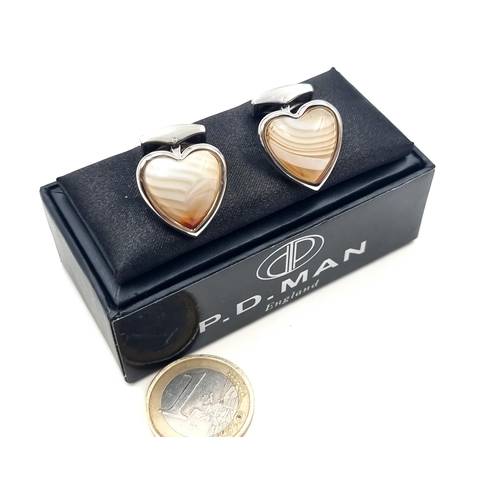 701 - A pair of Chanceldony stone heart shaped cuff links, by the designer P. W man. Presented in a gift b... 