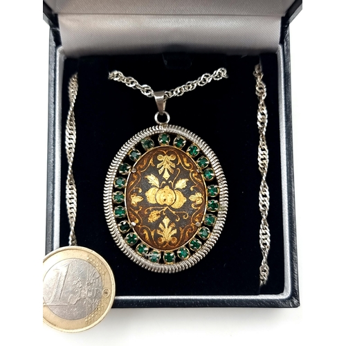 702 - A vintage beautiful  sterling silver oval pendant, set with floral gold inlay and an Emerald stone s... 