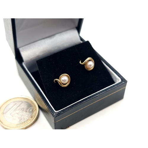 704 - A pair of 9 carat Gold Pearl stud earrings. Presented in a gift box.