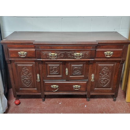 713 - An elegant early 20th century wooden sideboard. Quite an ornate example with bevelled and recessed p... 