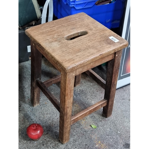 822 - A vintage Irish wooden stool with handle to top.