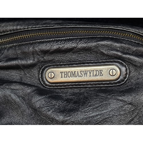 66 - Star Lot : A vintage Thomas Wylde soft black leather bag with iconic studded skull motif to front. S... 